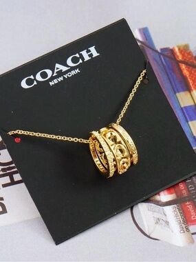 Coach Gold-Tone Filigree Spinner Pendant Necklace